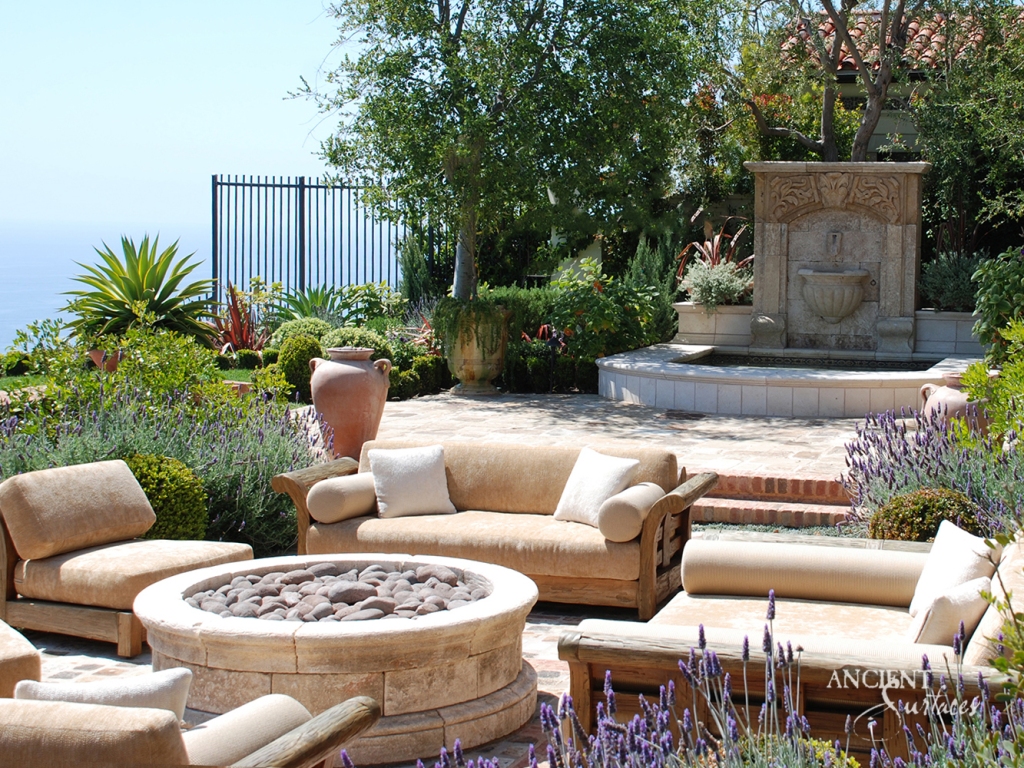 Limestone fire pit by Ancient Surfaces, evoking the timeless elegance of Mediterranean Italian architecture