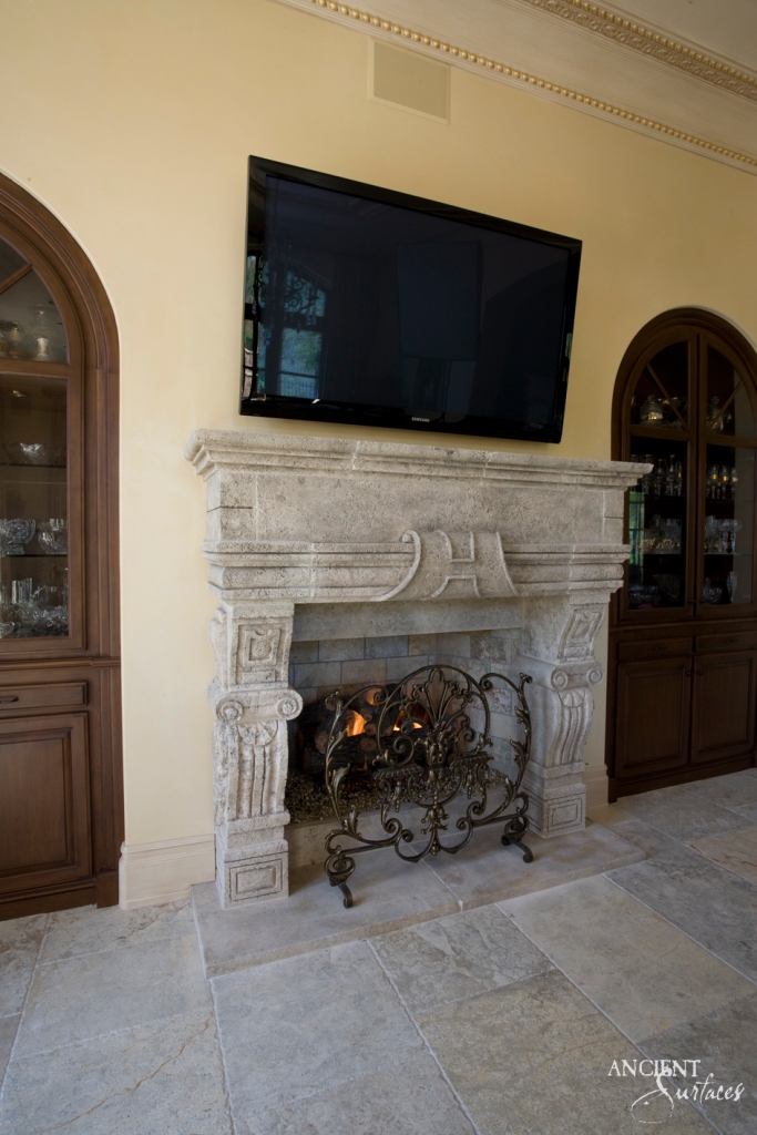 A sophisticated living room fireplace, where ancient stones encase a modern hearth, blending the primal allure of fire with contemporary aesthetics.